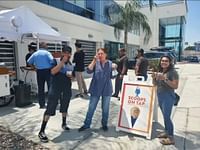 people taking a photo with an advertisement for an ice cream bar