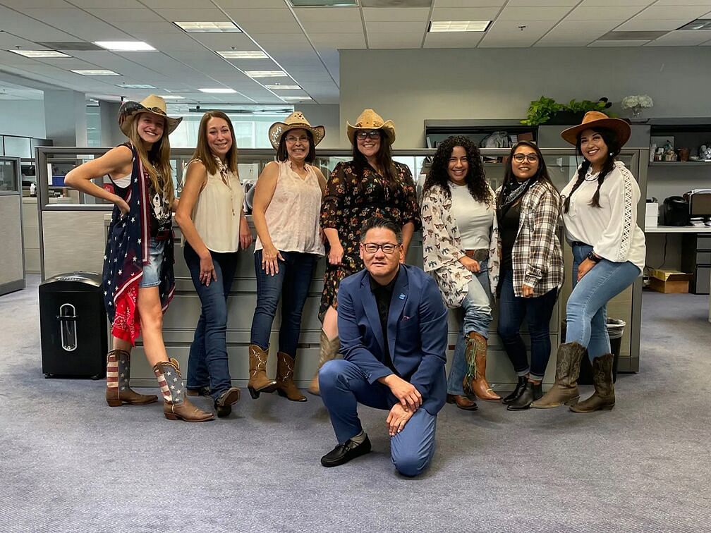 people posing to photos in  cowboy outfit