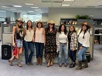 people posing to photos in  cowboy outfit