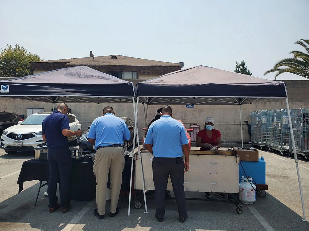 Employees choose tacos at a food truck