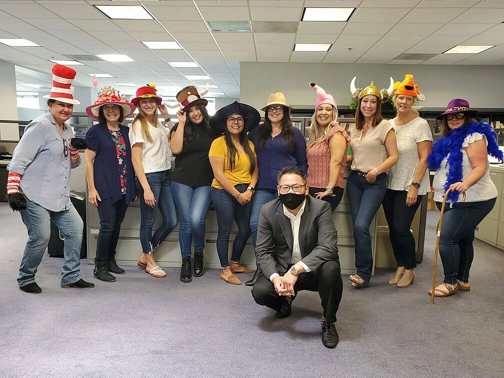 people posing to photos in  funny hats