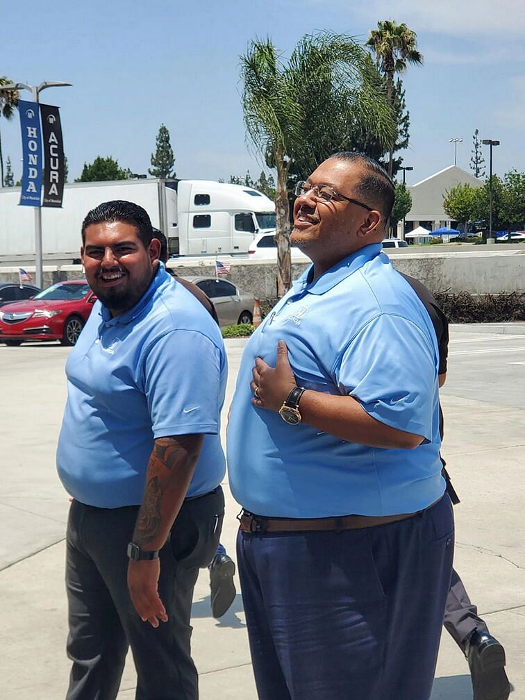 Two employees smiling
