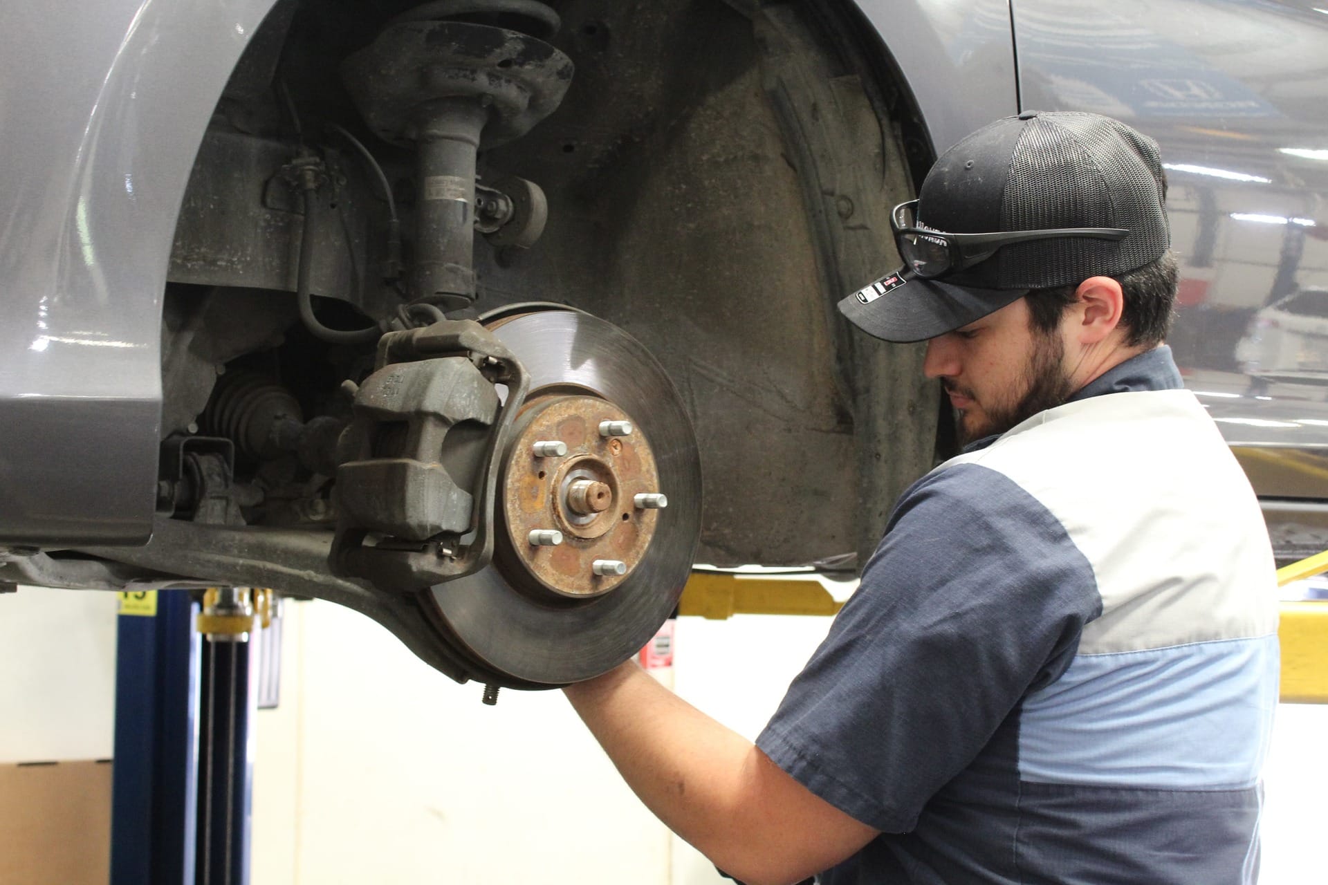 A mechanic replaces a wheel bearing