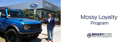 On the left man in suit standing next to blue ford in background mossy ford building, on the right black text Mossy Loyalty Program below Mossy Ford Pacific Beach logo on white background.