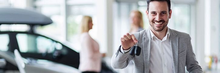 Dealership employee holding keys