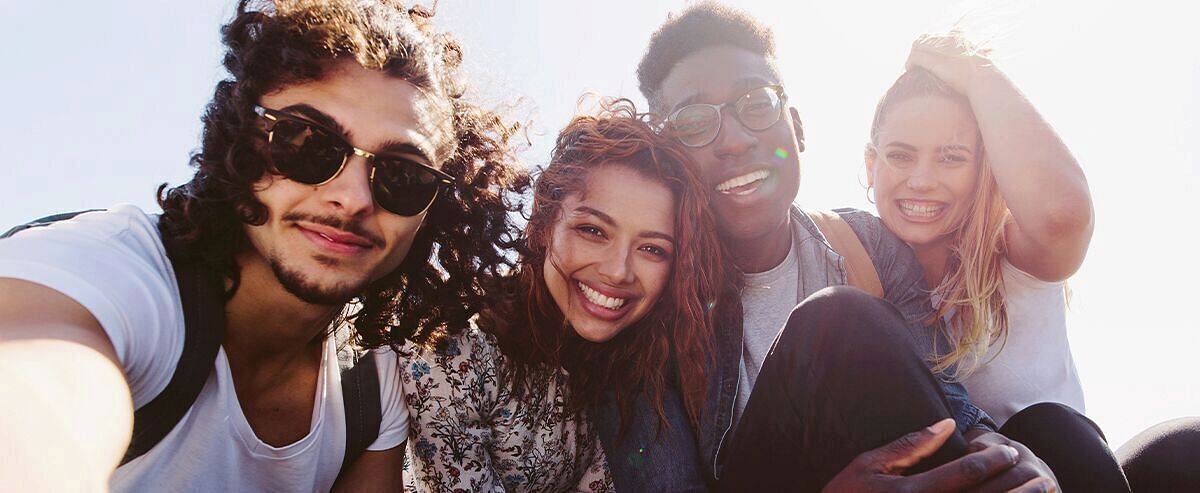 Group of happy friends taking a selfie on a nice day