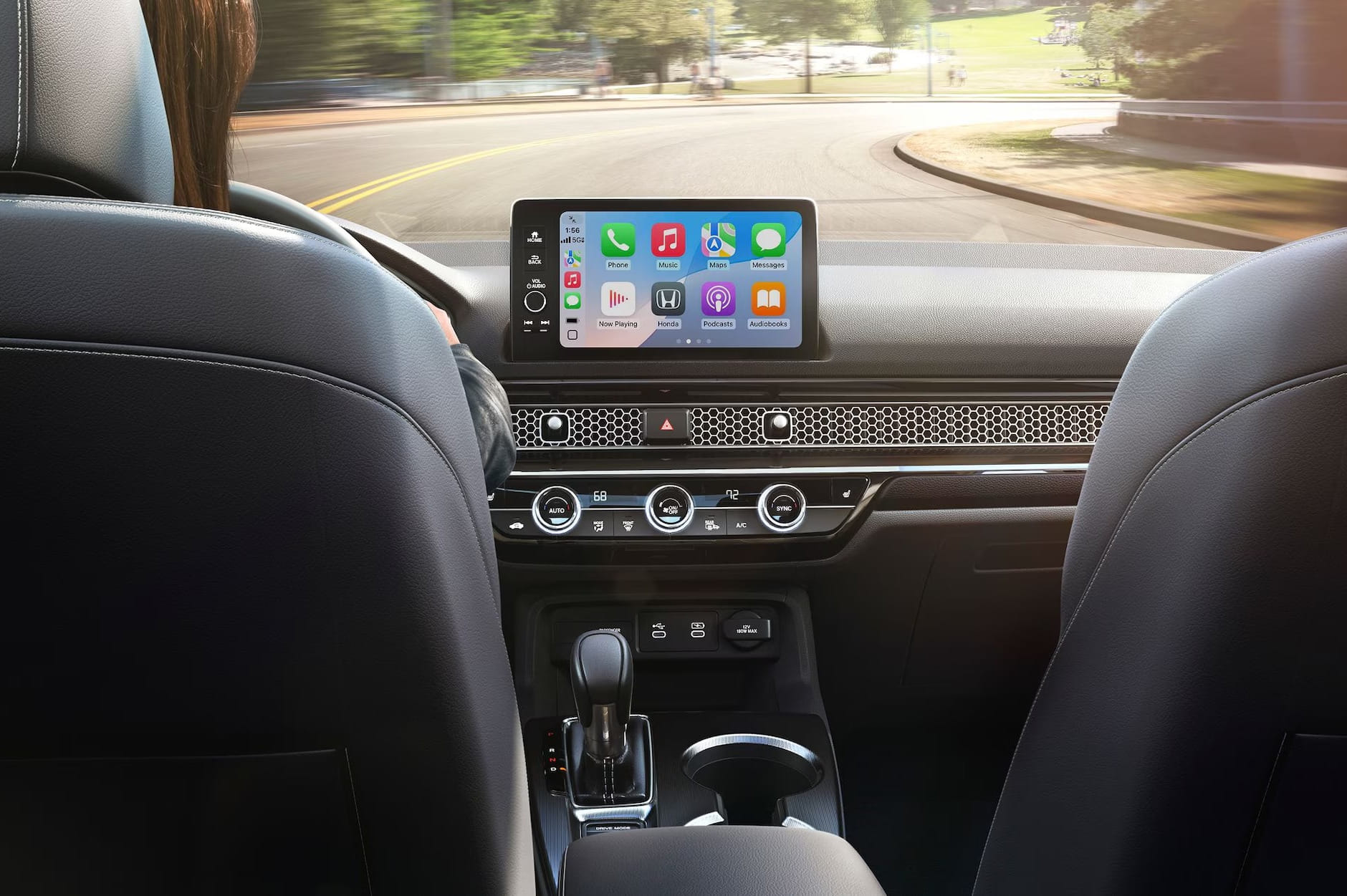 Interior of a 2026 Honda Civic Hatchback showing a dashboard with a digital display featuring app icons. The scene conveys a modern, tech-savvy atmosphere.