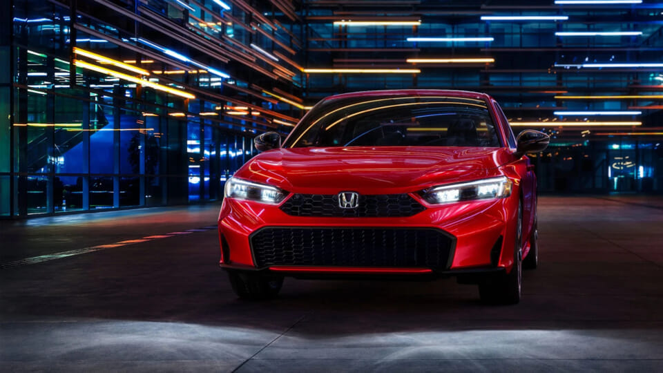 Un elegante auto rojo está estacionado en un garaje moderno iluminado con neón, emanando un sentimiento futurista y dinámico. Las luces están encendidas, reflejándose en la superficie brillante.