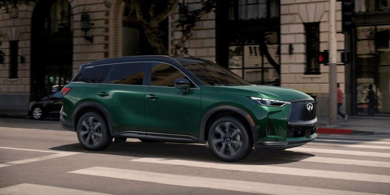 Exterior passenger side profile of 2026 INFINITI QX60 shown in Deep Emerald green color.