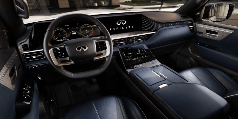 2026 INFINITI QX80 interior dashboard with driver's seat and steering wheel.