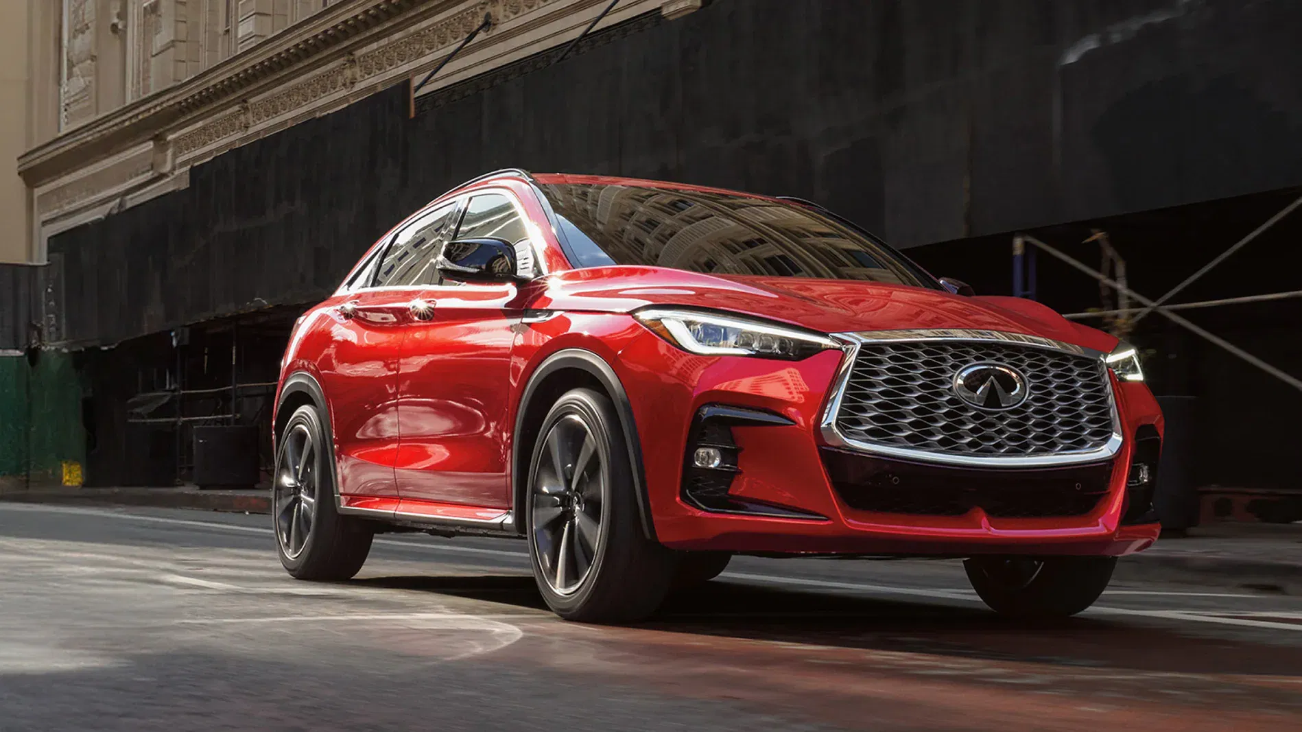 Front profile of an INFINITI QX55 shown in Dynamic Sunstone Red color