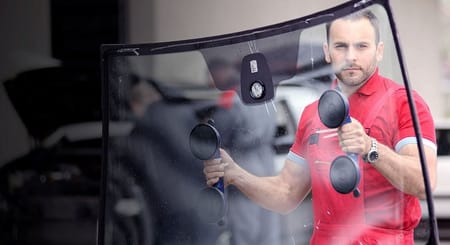 serviceman holding windshield