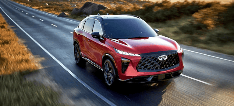 2027 INFINITI QX65 driving on a scenic road