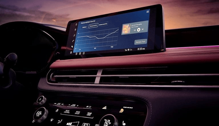 Driver interacting with infotainment screen of the 2027 QX65 highlighting use of the Personalized Sound application