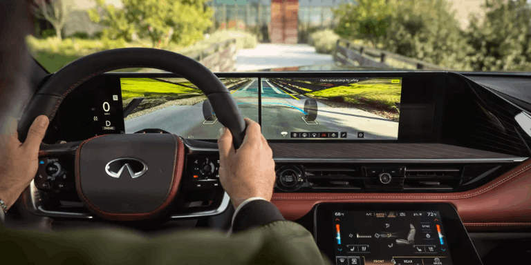 Mans hands on steering wheel of 2026 INFINITI QX80 highlighting Invisible Hood technology