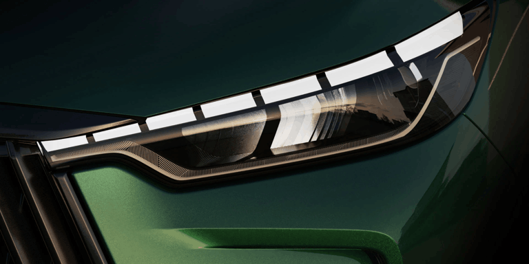 Close-up of 2026 INFINITI QX60 LED headlight with signature lighting.