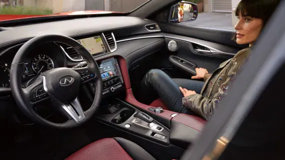 Interior view of woman sitting in front passenger seat of INFINITI QX60