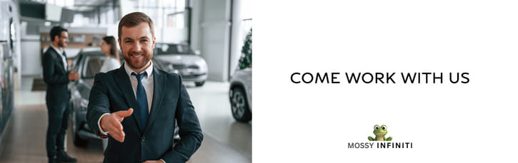 A smiling man in a suit offers a handshake in a car showroom. Other people converse in the background. The text reads "Come Work With Us," with the Mossy Infiniti logo.