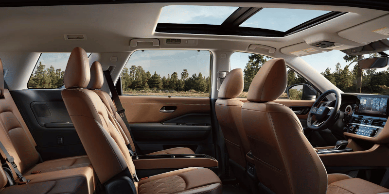 2026 Nissan Pathfinder interior with Chestnut Semi-aniline Leather seats and quilted inserts, from the passenger side.