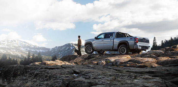 2026 Frontier Crew Cab PRO-4X parked on a rocky outcrop in the mountains.