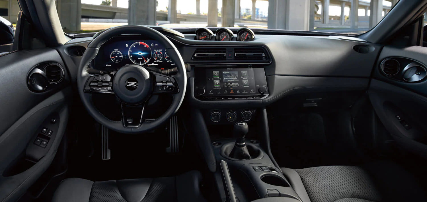 The driver-focused cockpit of the 2026 Nissan Z, showing the 12.3-inch digital dashboard in Sport Mode.
