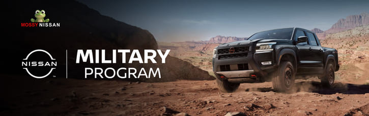 Black pickup truck driving off-road on a dusty trail with red rock formations in the background. Text reads "Nissan Military Program." Rugged and adventurous tone.