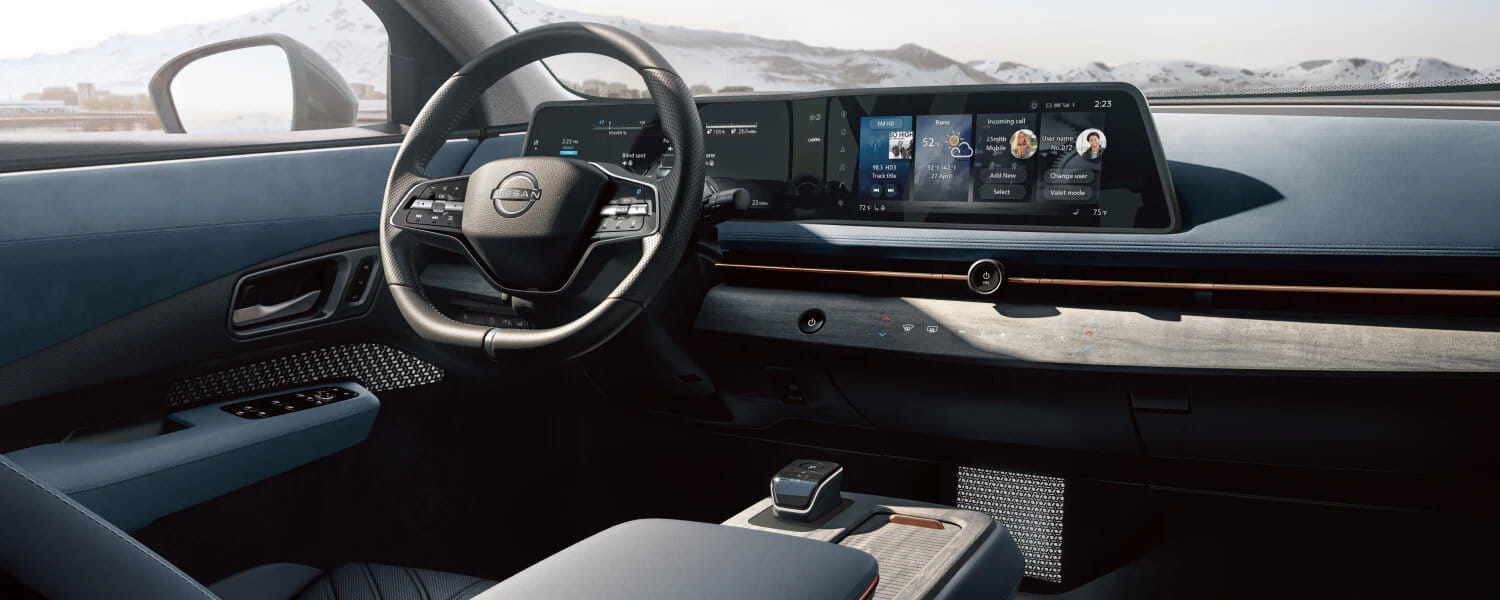 Sleek modern car interior with a digital dashboard displaying navigation and apps. Minimalist steering wheel and expansive mountain view outside.