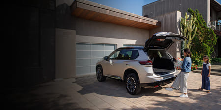 2026 Rogue parked in driveway as driver opens the Motion Activated Liftgate with her foot.