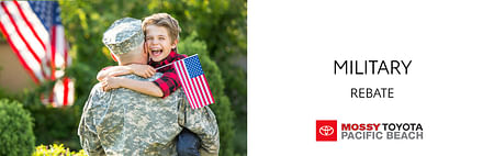 On the left, a man in a military uniform holds a smiling boy with a U.S. flag in his arms, on the right black text Military Rebate on white background, below mossy toyota logo