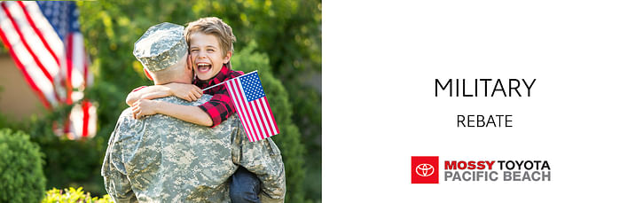 On the left, a man in a military uniform holds a smiling boy with a U.S. flag in his arms, on the right black text Military Rebate on white background, below mossy toyota logo