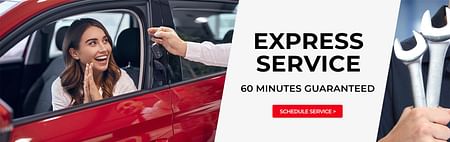 A young lady smiling while a person is handing her the keys to a car - Express Service 60 MINUTES GUARNATEED
