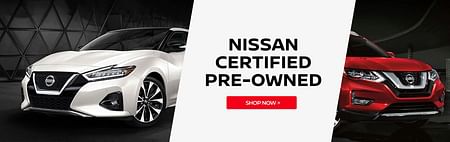 The front part of a white Nissan Maxima and a red Nissan Kicks - NISSAN CERTIFIED PRE-OWNED