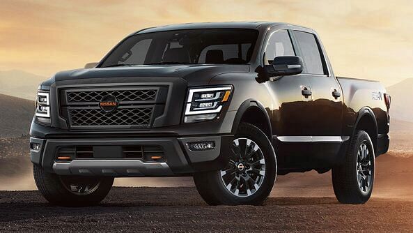 black nissan titan standing in the desert at sunset