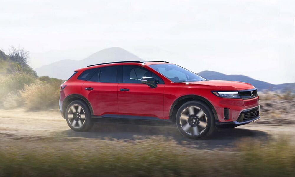 red honda prologue driving through the wilderness