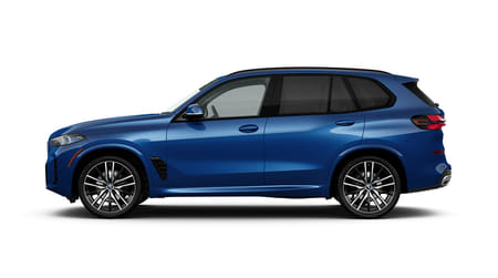  Driver side view of a blue 2026 BMW X5 on a white background.