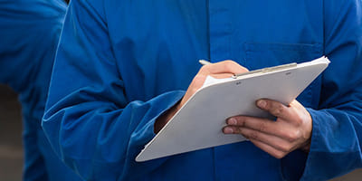 Mechanic taking notes