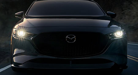 The front end of a black Mazda3.