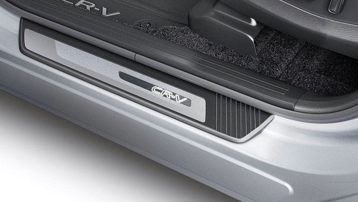 A close-up of the CR-V logo on the car's door sill plate.