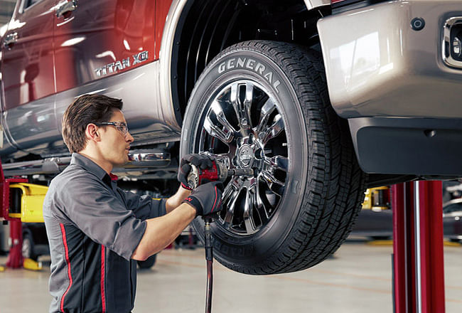 A service technician unscrewing a wheel