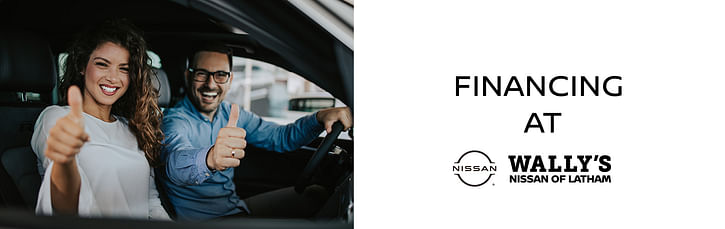 On the left, a man and a woman sitting in the front seats of the car showing thumbs up, on the right black text FINANCING AT Wally's Nissan of Latham on the white background