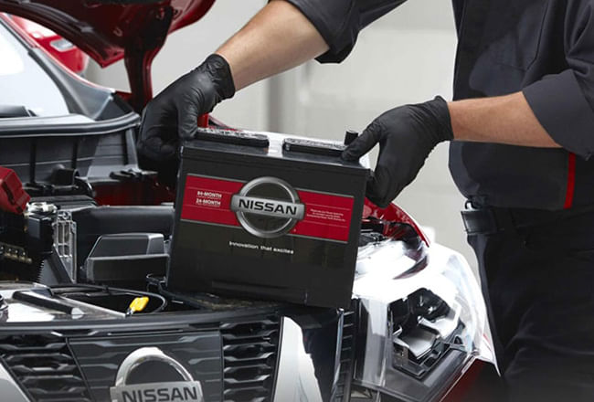 A service technician replacing an accumulator.