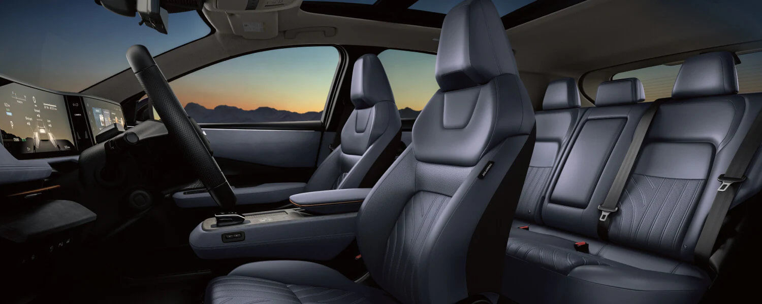 Wide view of the 2025 Nissan ARIYA’s lounge-like interior, featuring premium materials and ambient lighting.