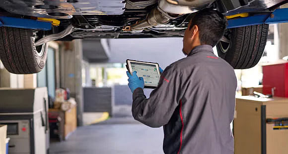 Nissan technician inspecting a vehicle