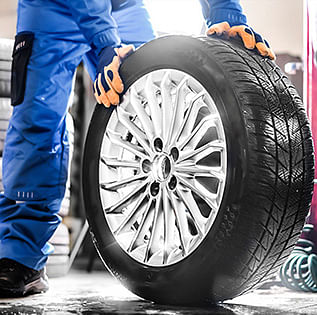 A man holding car wheel