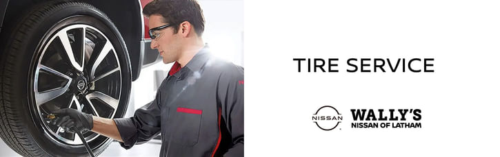 On the left, a service technician pumping a wheel, on the right black text TIRE SERVCIE, below Wally's Nissan of Latham logo on the white background