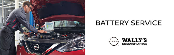On the left, a service technician checking the onboard computer of a red nissan, on the right black text BATTERY SERVICE, below Wally's Nissan of Latham logo on the white background