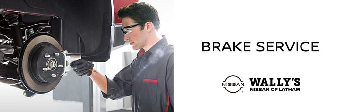 On the left, a serviceman checking brake discs, on the right black text BRAKE SERVICE below Wally's Nissan of Latham logo on the white background