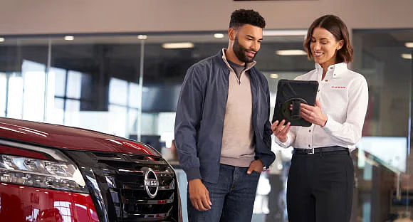 Nissan salesperson showing a client notes