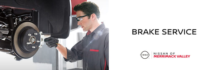 A banner for Brake Service at Nissan of Merrimack Valley with a mechanic working on a car's brake rotor.