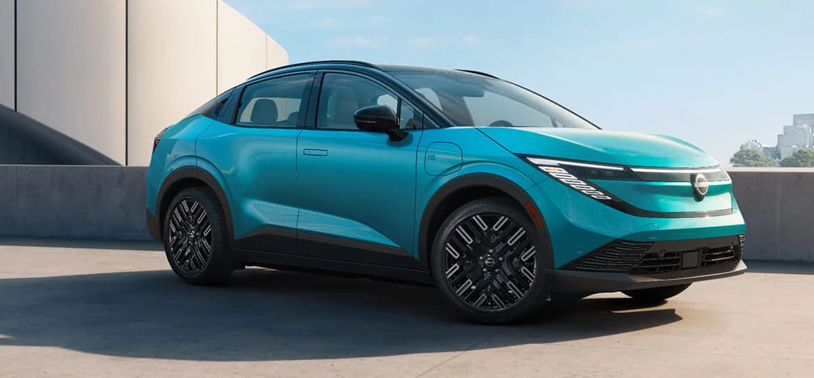 Side profile of the 2026 Nissan Leaf, showcasing its sleek new crossover design and aerodynamic lines.